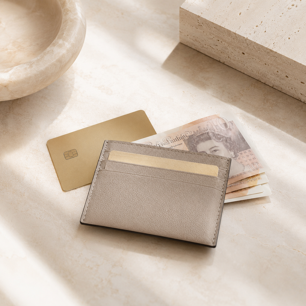 Wallet and cash on pale stone